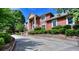 Brick home with landscaped yard and large driveway at 619 Champions Dr, Mcdonough, GA 30253