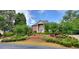 Brick home with manicured landscaping and driveway at 619 Champions Dr, Mcdonough, GA 30253