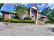 Brick house with landscaping and a large driveway at 619 Champions Dr, Mcdonough, GA 30253
