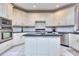 Kitchen features white cabinets, granite countertops, and stainless steel appliances at 619 Champions Dr, Mcdonough, GA 30253