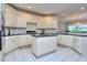 Large kitchen featuring an island, white cabinets, and granite countertops at 619 Champions Dr, Mcdonough, GA 30253