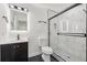 Modern bathroom with marble tile, glass shower, and dark vanity at 1111 Osborne Sw St, Atlanta, GA 30310