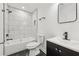 Modern bathroom with marble tile shower, bathtub, and black fixtures at 1111 Osborne Sw St, Atlanta, GA 30310