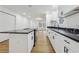 Modern kitchen with white cabinets, black countertops, and island at 1111 Osborne Sw St, Atlanta, GA 30310