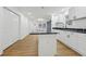 Modern kitchen boasts white cabinets, black countertops, and an island at 1111 Osborne Sw St, Atlanta, GA 30310