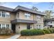 Tan two-story stucco home with dark gray accents and landscaping at 295 Lakemoore Ne Dr # F, Atlanta, GA 30342