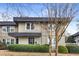 Tan two-story stucco home with dark gray accents and landscaping at 295 Lakemoore Ne Dr # F, Atlanta, GA 30342