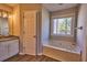 Bathroom with garden tub and updated vanity at 3865 Chastatee Dr, Duluth, GA 30097