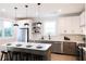 Modern kitchen with white cabinets, floating shelves, and stainless steel appliances at 508 Casanova Se St, Atlanta, GA 30315