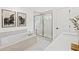 Luxurious bathroom featuring a soaking tub, separate shower, and marble countertops at 5756 Tillman Way, Powder Springs, GA 30127