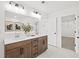 Beautiful bathroom with double sinks, wood cabinets, and a view of the walk-in closet at 5756 Tillman Way, Powder Springs, GA 30127