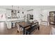 Modern kitchen with stainless steel appliances, white cabinets, and an island with bar stool seating at 5756 Tillman Way, Powder Springs, GA 30127