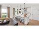 Stylish kitchen with stainless steel appliances, white cabinets, and an island with bar stool seating at 5756 Tillman Way, Powder Springs, GA 30127