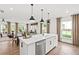 Open-concept kitchen featuring an island with bar seating and a view of the living area at 5756 Tillman Way, Powder Springs, GA 30127
