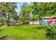 Spacious grassy backyard, featuring a storage shed, fenced perimeter, and shady trees, perfect for outdoor activities at 1770 Rockland Se Dr, Atlanta, GA 30316