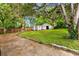 Large grassy backyard, featuring a storage shed, fenced perimeter, and shady trees, perfect for outdoor activities at 1770 Rockland Se Dr, Atlanta, GA 30316