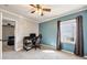 Comfortable bedroom with neutral carpet, large window, blue accent wall, and ample space for a desk and chair at 1770 Rockland Se Dr, Atlanta, GA 30316