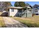 Cozy home with a quaint front porch and private driveway on a beautiful, sunny day at 1770 Rockland Se Dr, Atlanta, GA 30316