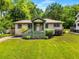 Quaint single-story home with a well-kept lawn, front porch, and clean, attractive landscaping at 1770 Rockland Se Dr, Atlanta, GA 30316