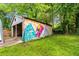 Open garage featuring unique mural art on the exterior wall at 1770 Rockland Se Dr, Atlanta, GA 30316