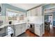 Cozy kitchen with white cabinets, hardwood floors, stainless steel appliances, and a window overlooking the backyard at 1770 Rockland Se Dr, Atlanta, GA 30316