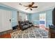 Comfortable living room with plush leather seating, a ceiling fan, and a stylish patterned rug at 1770 Rockland Se Dr, Atlanta, GA 30316