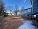 Backyard view of home with elevated deck and storage shed at 220 Canterbury Ln, Lawrenceville, GA 30046