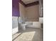 Full bathroom featuring a white vanity, toilet, and shower-tub combo with lavender walls at 220 Canterbury Ln, Lawrenceville, GA 30046