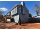 Side view of charming blue house with deck and well-maintained yard at 220 Canterbury Ln, Lawrenceville, GA 30046