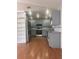 Bright kitchen features gray cabinetry, stainless steel appliances, recessed lighting, and wood flooring at 220 Canterbury Ln, Lawrenceville, GA 30046