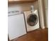 Laundry room with wood flooring and a white washer and dryer at 220 Canterbury Ln, Lawrenceville, GA 30046