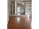 Living room with hardwood floors, built-in bookshelves, and natural lighting at 220 Canterbury Ln, Lawrenceville, GA 30046