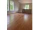 Large living room with natural lighting and hardwood floors at 220 Canterbury Ln, Lawrenceville, GA 30046