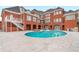 Large kidney shaped pool, brick patio, hot tub, and grilling area at 2280 Wilshire Dr, Grayson, GA 30017