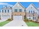 Three-unit townhome development showcasing attractive brick and siding exteriors at 5619 Tillman Way, Powder Springs, GA 30127