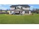 The backyard view includes a covered patio, green grass, and a view of the rear exterior at 5270 Birch Valley Rd, Cumming, GA 30028