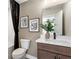Well-lit bathroom with modern fixtures, decorative art, and a combined bathtub and shower at 5270 Birch Valley Rd, Cumming, GA 30028