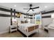 Nicely decorated bedroom featuring eye-catching wall stripes, a plush bed, and a large window at 5270 Birch Valley Rd, Cumming, GA 30028