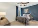 Bedroom with metal bed frame, blue accent wall, and ceiling fan at 5270 Birch Valley Rd, Cumming, GA 30028