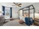 Bedroom with a full-size bed, a white armchair, and a large window at 5270 Birch Valley Rd, Cumming, GA 30028