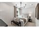 Cozy bedroom with a neutral color palette, a comfortable bed, and stylish lighting at 5270 Birch Valley Rd, Cumming, GA 30028