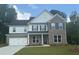 Beautiful new two-story home featuring brick and siding exterior, a two-car garage, and a well-maintained lawn at 5270 Birch Valley Rd, Cumming, GA 30028