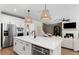 Bright, open kitchen featuring an island with seating, stainless steel appliances, and an adjoining living area at 5270 Birch Valley Rd, Cumming, GA 30028