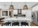 Kitchen with a large island, modern appliances, and stylish pendant lighting at 5270 Birch Valley Rd, Cumming, GA 30028