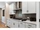 Contemporary kitchen with sleek countertops, stainless steel range hood, gas cooktop, and modern cabinetry at 5270 Birch Valley Rd, Cumming, GA 30028