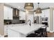 Modern kitchen with white cabinets, a large island, stainless steel appliances, and stylish pendant lighting at 5270 Birch Valley Rd, Cumming, GA 30028