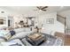 Spacious living room with sectional sofa, coffee table, and hardwood floors at 5270 Birch Valley Rd, Cumming, GA 30028