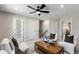 Cozy living room with a ceiling fan, neutral decor, and two chairs with green throw pillows at 5270 Birch Valley Rd, Cumming, GA 30028