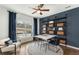 Home office with a desk, shelving, and a large window at 5270 Birch Valley Rd, Cumming, GA 30028