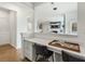 Built-in desk with white cabinetry and two black chairs at 5270 Birch Valley Rd, Cumming, GA 30028